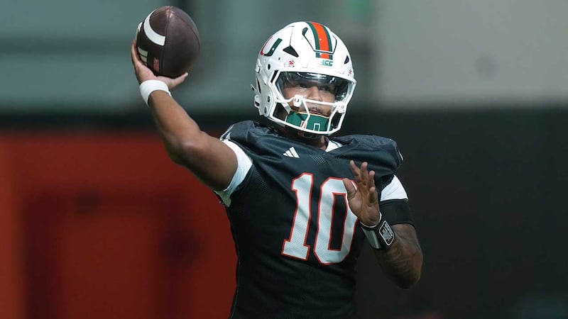 Miami quarterback Darian Mensah (10) throws a pass during a practice session at their training...