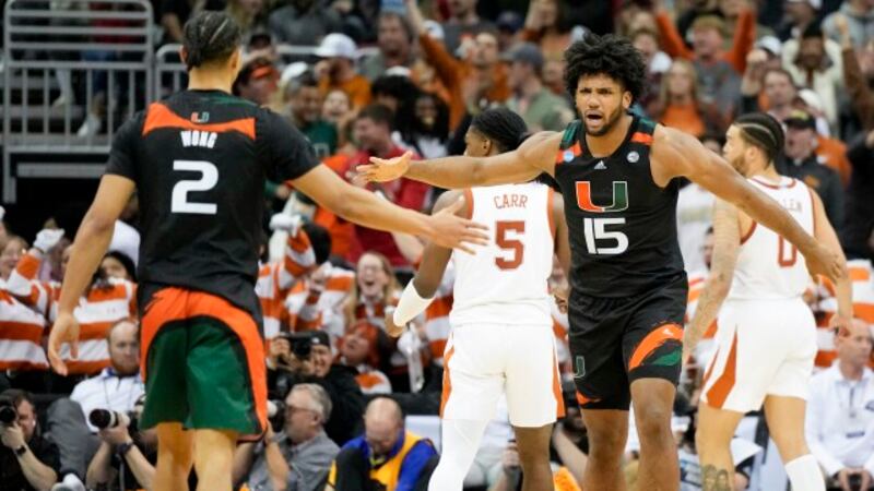 Miami forward Norchad Omier celebrates after scoring against Texas in the second half of an...
