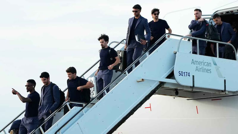 Portugal players disembark from an airplane as they arrive for the World Cup soccer...